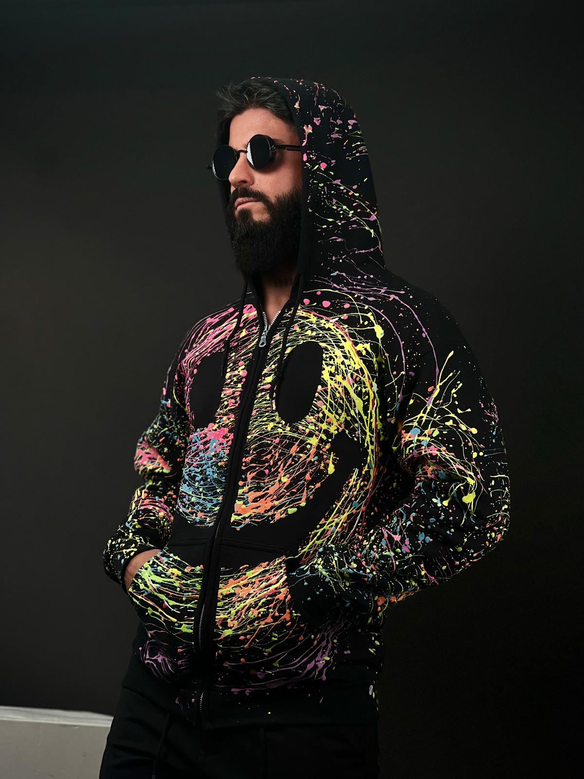 Unisex Handmade Hoodie with Glow-in-the-Dark Paint Splatter – Featuring a Large Smiley Design – Part of the Exclusive Halloween Collection